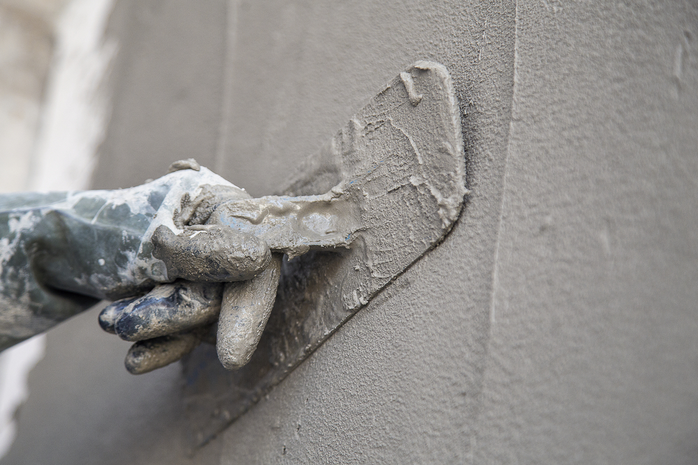 Plasterer,Concrete,Worker,At,Wall,Of,House,Construction